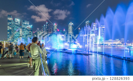 Light and Water Show along promenade in front of Marina Bay Sands timelapse 128826393