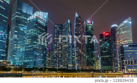 Singapore business district skyscrapers in the night time with water reflections timelapse hyperlapse 128826410