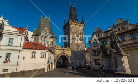 A view along Charles Bridge in Prague towards the Lesser Quarter in the morning timelapse hyperlapse. 128826621