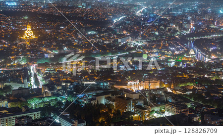 Holy Trinity Cathedral of Tbilisi, the Ceremonial Palace of Georgia and concert hall in Rike Park aerial night timelapse. Holy Trinity Cathedral of Tbilisi, the Ceremonial Palace of Georgia and concert hall in Rike Park aerial night timelapse. 128826709