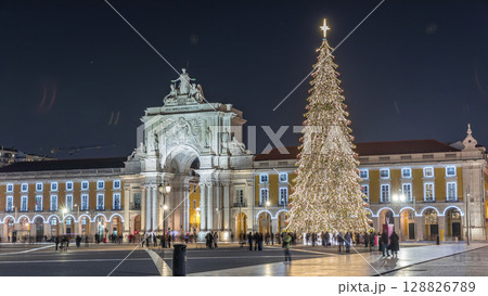 Commerce Square in Lisbon illuminated at Christmas hyperlapse, with a towering tree and crowds celebrating at night. Portugal Commerce Square in Lisbon illuminated at Christmas hyperlapse, with a towering tree and crowds celebrating at night. Portugal 128826789