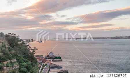 Aerial timelapse from a hill near Porto Brandao Ferry Station on the Tagus River in Lisbon 128826795
