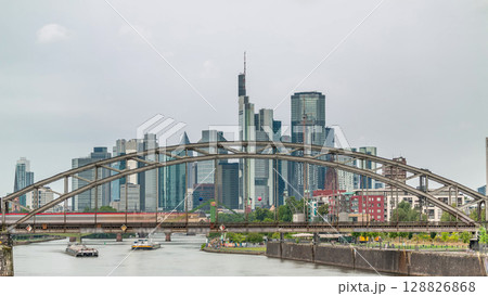 Aerial timelapse of Frankfurt's skyline through the arch of Deutschherrnbrucke Railway Bridge. Germany 128826868