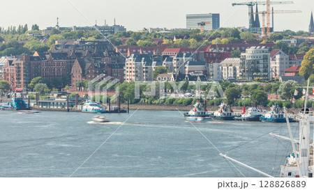 Aerial timelapse of Elbe riverside in Hamburg, Germany. Scenic view with boats near the pier Aerial timelapse of Elbe riverside in Hamburg, Germany. Scenic view with boats near the pier 128826889