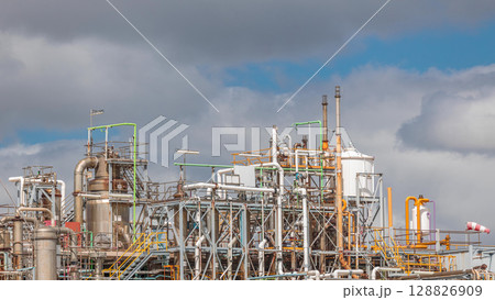 Distillation Columns and their process equipment of hydrogen plant timelapse with clouds on a background. 128826909