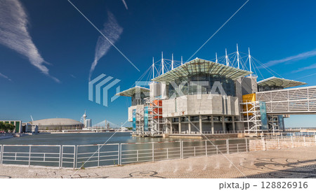 Lisbon oceanarium timelapse hyperlapse building on pier in an artificial lagoon at Tagus river estuary in parque das nacoes Lisbon oceanarium timelapse hyperlapse building on pier in an artificial lagoon at Tagus river estuary in parque das nacoes 128826916