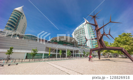 Visitors coming in and out of the Vasco da Gama Shopping mall timelapse hyperlapse, modern towers in the background. Lisbon, Portugal Visitors coming in and out of the Vasco da Gama Shopping mall timelapse hyperlapse, modern towers in the background. Lisbon, Portugal 128826918