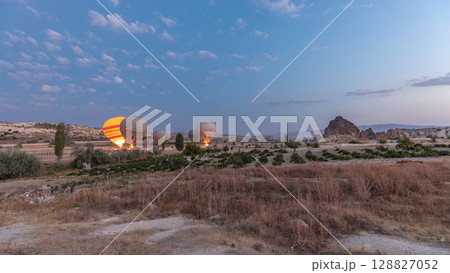 Beautiful colorful hot air balloons take off and flying in clear morning sky timelapse in Cappadocia, Turkey 128827052