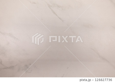 Smooth white marble surface with subtle gray veining creating a clean and elegant backdrop 128827736