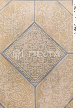 Decorative floor tile featuring intricate patterns in soft earthy tones Decorative floor tile featuring intricate patterns in soft earthy tones 128827813
