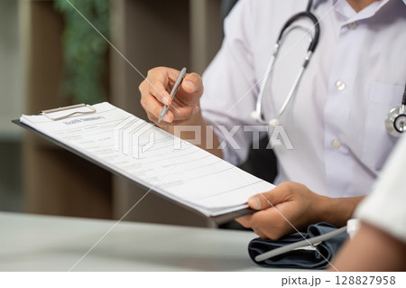 Healthcare Consultation. Doctor reviewing health summary with patient. Healthcare Consultation. Doctor reviewing health summary with patient. 128827958