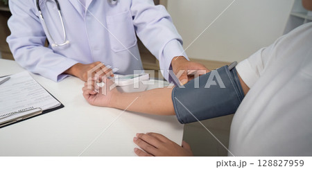 Blood Pressure Measurement. Doctor using device on patient arm. Blood Pressure Measurement. Doctor using device on patient arm. 128827959