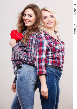 adult daughter and mother with heart love sign adult daughter and mother with heart love sign 128828481