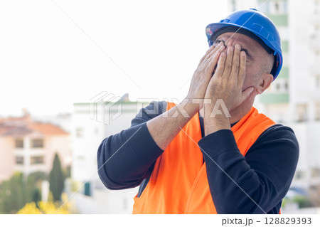Stressed and worried mechanical technician or building contractor 128829393
