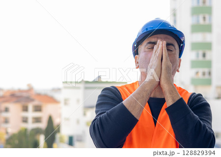 Stressed and worried mechanical technician or building contractor 128829394