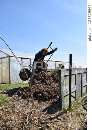 Young man engaged in household chores and small-scale rural farming, tending to his garden with care and dedication. His daily routine reflects a sustainable and self-sufficient way of life 128829966