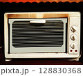 Old electric oven built into a sideboard shelf 128830368