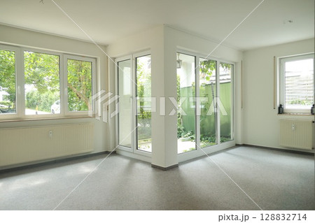 Large room with a white wall and a white door Large room with a white wall and a white door 128832714