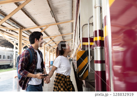 Couple boarding train with excitement and joy 128832919