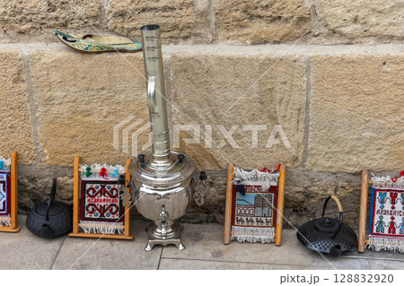 Traditional Decor with Samovar and Colorful Weaving Near Stone Wall Traditional Decor with Samovar and Colorful Weaving Near Stone Wall 128832920