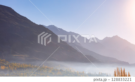 The autumn scenery with Hindu Kush mountain range in the background is very beautiful, Gahkuch,northern Pakistan. 128833221