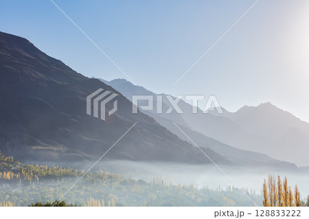 The autumn scenery with Hindu Kush mountain range in the background is very beautiful, Gahkuch,northern Pakistan. 128833222