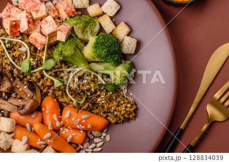 Food bowl with tofu, quinoa, broccoli and carrots, microgreens 128834039