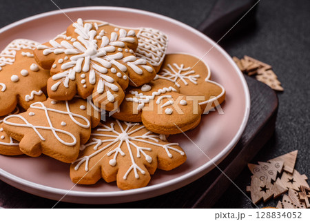 Christmas winter gingerbread, holiday biscuits on monochrome background Christmas winter gingerbread, holiday biscuits on monochrome background 128834052