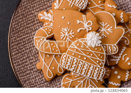 Christmas winter gingerbread, holiday biscuits on monochrome background Christmas winter gingerbread, holiday biscuits on monochrome background 128834065