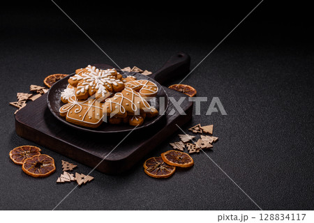 Christmas winter gingerbread, holiday biscuits on monochrome background Christmas winter gingerbread, holiday biscuits on monochrome background 128834117