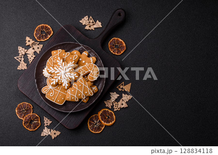 Christmas winter gingerbread, holiday biscuits on monochrome background Christmas winter gingerbread, holiday biscuits on monochrome background 128834118