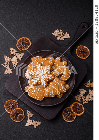 Christmas winter gingerbread, holiday biscuits on monochrome background Christmas winter gingerbread, holiday biscuits on monochrome background 128834119