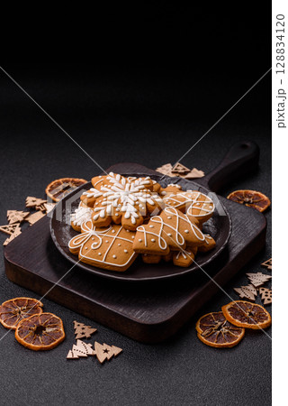 Christmas winter gingerbread, holiday biscuits on monochrome background Christmas winter gingerbread, holiday biscuits on monochrome background 128834120
