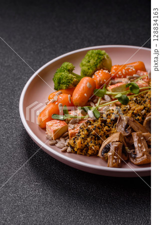 Food bowl with tofu, quinoa, broccoli and carrots, microgreens 128834163