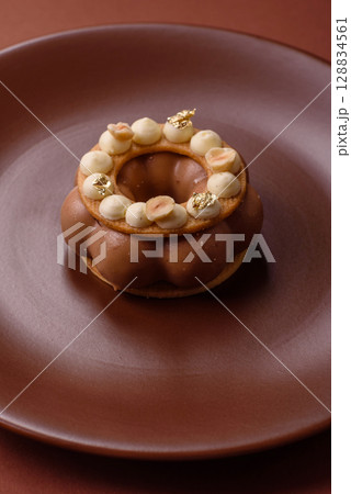 Round chocolate tart or pie with cream berry filling Round chocolate tart or pie with cream berry filling 128834561