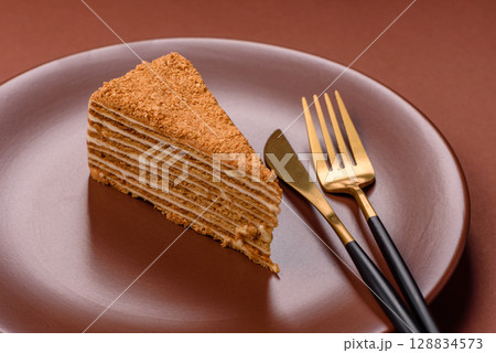 A slice of honey puff cake or pumpkin, carrot and cream pie, vegan sweets 128834573