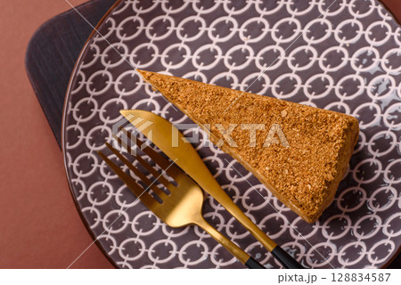 A slice of honey puff cake or pumpkin, carrot and cream pie, vegan sweets 128834587