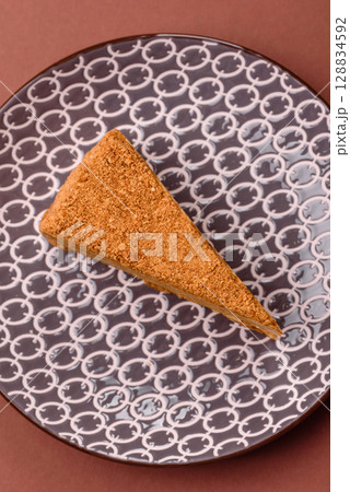 A slice of honey puff cake or pumpkin, carrot and cream pie, vegan sweets A slice of honey puff cake or pumpkin, carrot and cream pie, vegan sweets 128834592