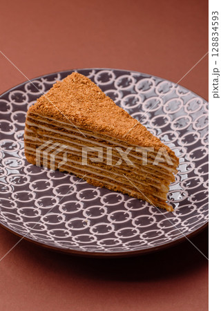 A slice of honey puff cake or pumpkin, carrot and cream pie, vegan sweets A slice of honey puff cake or pumpkin, carrot and cream pie, vegan sweets 128834593