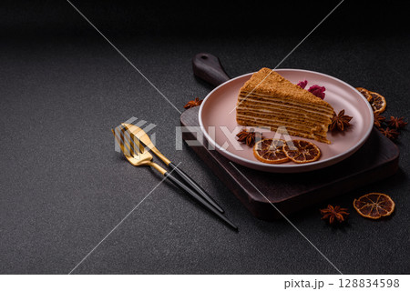A slice of honey puff cake or pumpkin, carrot and cream pie, vegan sweets 128834598