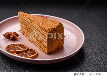 A slice of honey puff cake or pumpkin, carrot and cream pie, vegan sweets 128834606