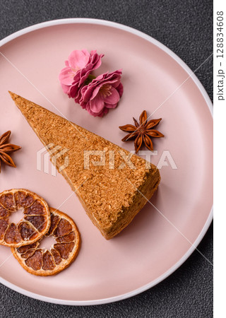 A slice of honey puff cake or pumpkin, carrot and cream pie, vegan sweets 128834608