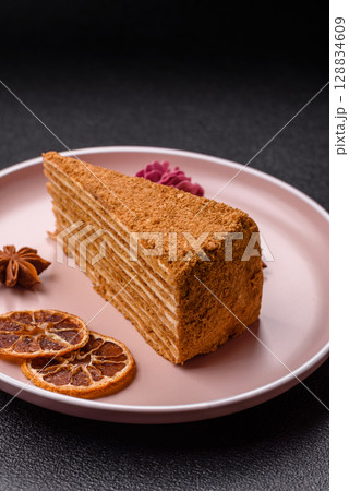 A slice of honey puff cake or pumpkin, carrot and cream pie, vegan sweets 128834609