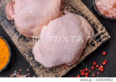 Chicken thigh raw, fresh poultry meat with salt and spices Chicken thigh raw, fresh poultry meat with salt and spices 128834662