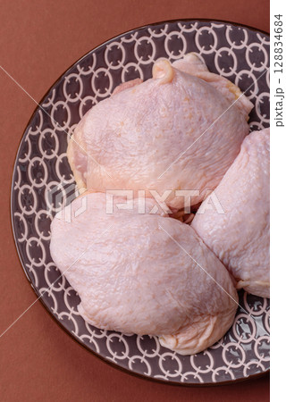 Chicken thigh raw, fresh poultry meat with salt and spices Chicken thigh raw, fresh poultry meat with salt and spices 128834684