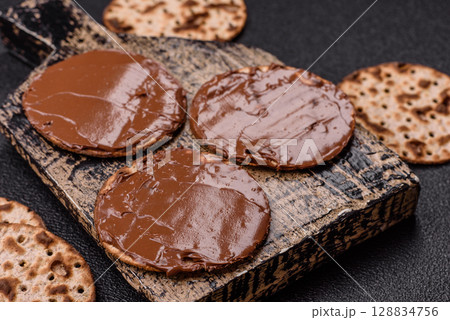 Matzah with chocolate paste for the Jewish holiday of passover Matzah with chocolate paste for the Jewish holiday of passover 128834756