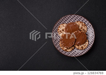 Matzah with chocolate paste for the Jewish holiday of passover Matzah with chocolate paste for the Jewish holiday of passover 128834769