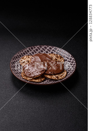 Matzah with chocolate paste for the Jewish holiday of passover Matzah with chocolate paste for the Jewish holiday of passover 128834773