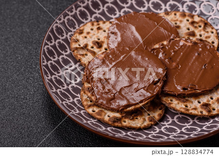 Matzah with chocolate paste for the Jewish holiday of passover Matzah with chocolate paste for the Jewish holiday of passover 128834774