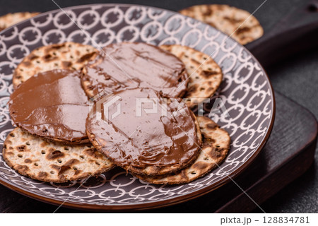 Matzah with chocolate paste for the Jewish holiday of passover 128834781